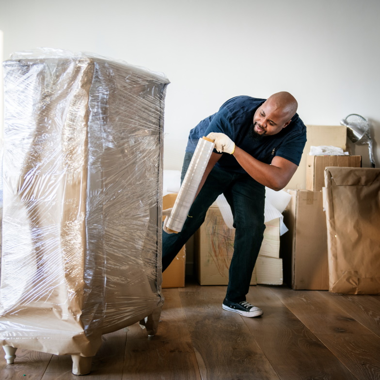 Black man moving furniture